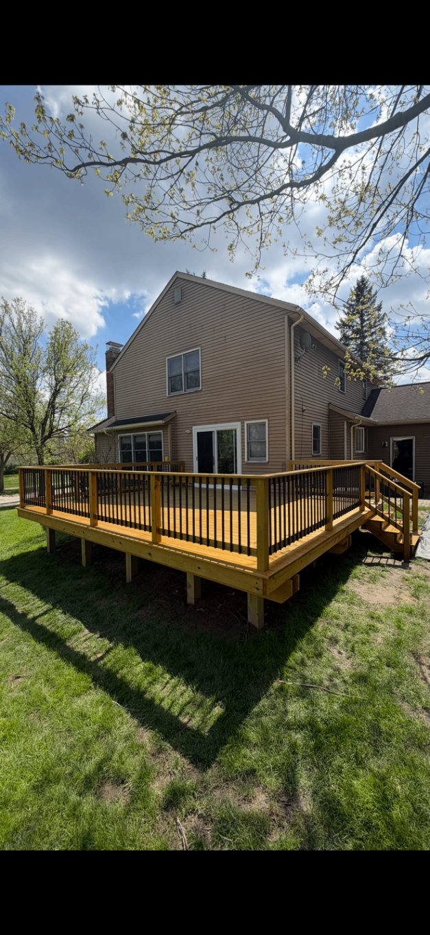 Custom deck with black iron railings and new steps built by Legacy Builders in Northeast Ohio